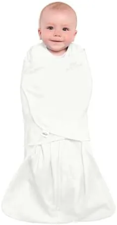 Baby swaddled in the cream HALO SleepSack Swaddle, arms in